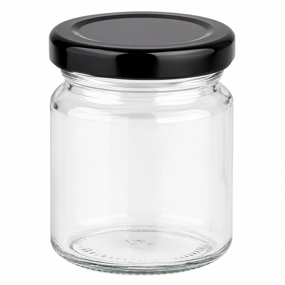 Barattolo rotondo da 53 ml con coperchio BasicSeal nero UNiTWIST. Barattolo rotondo da 53 ml con coperchio nero BasicSeal vuoto su sfondo bianco piccolo barattolo di vetro per la conservazione