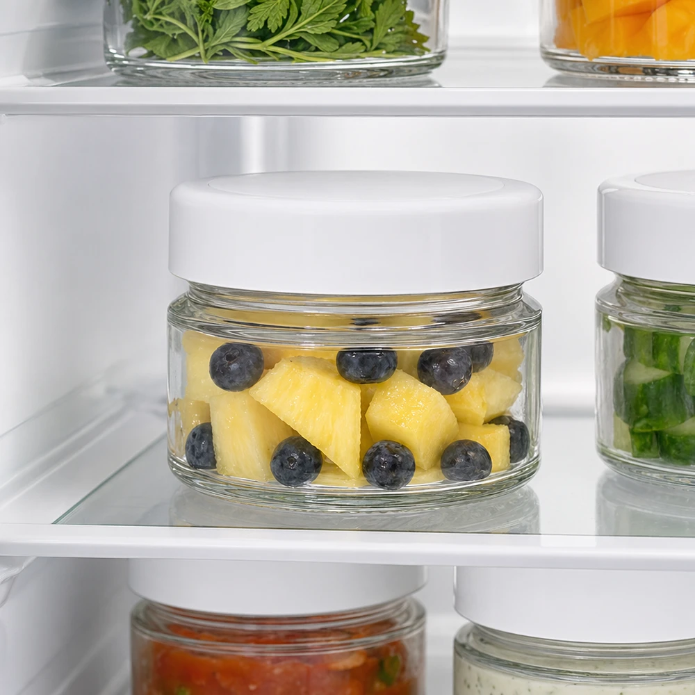 Barattolo rotondo da 80 ml con coperchio BasicSeal bianco profondo UNi... Un barattolo rotondo da 80 ml in frigorifero con ananas e mirtilli mostra le proprietà ottimali di conservazione della freschezza del coperchio BasicSeal