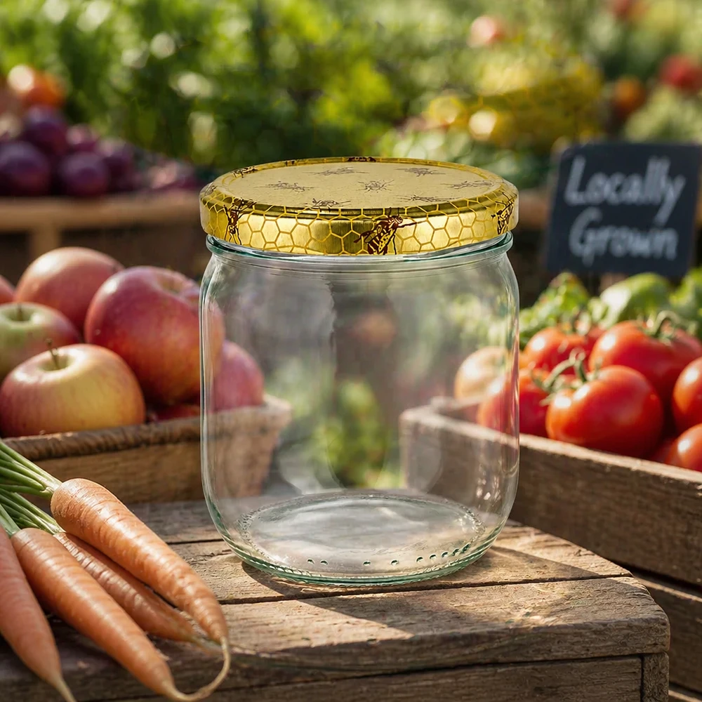 Vasetto per miele da 500 g con capsula con motivo a favo BasicSeal UNiTWIST Vasetto di miele vuoto da 500 g con coperchio a nido d'ape su una tavola di legno tra le verdure fresche del mercato contadino