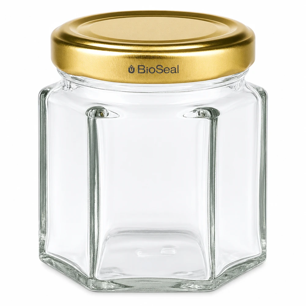 Vasetto per miele da 60 g con capsula dorata BioSeal UNiTWIST Vasetto esagonale da 60 g con coperchio dorato a vite BioSeal UNiTWIST per miele e marmellata