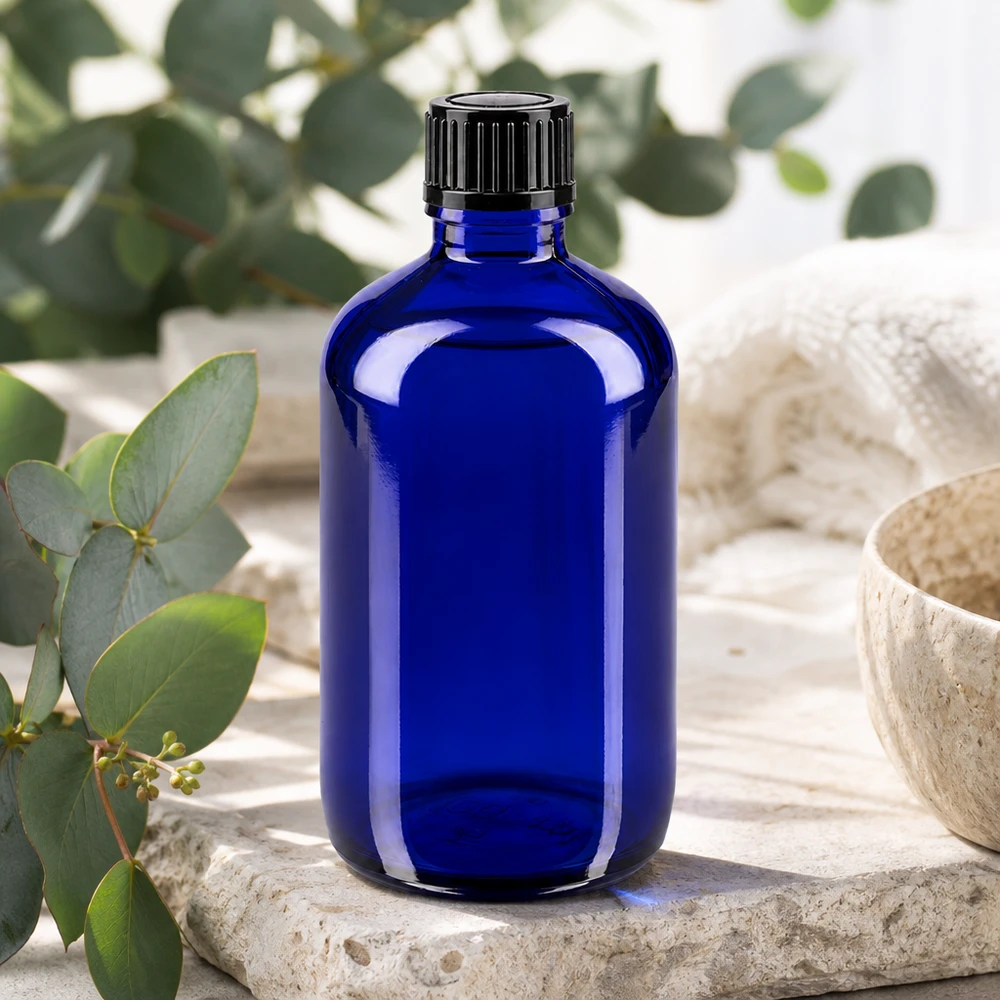 Flacone da farmacia blu da 100 ml con tappo standard nero su pietra naturale con eucalipto